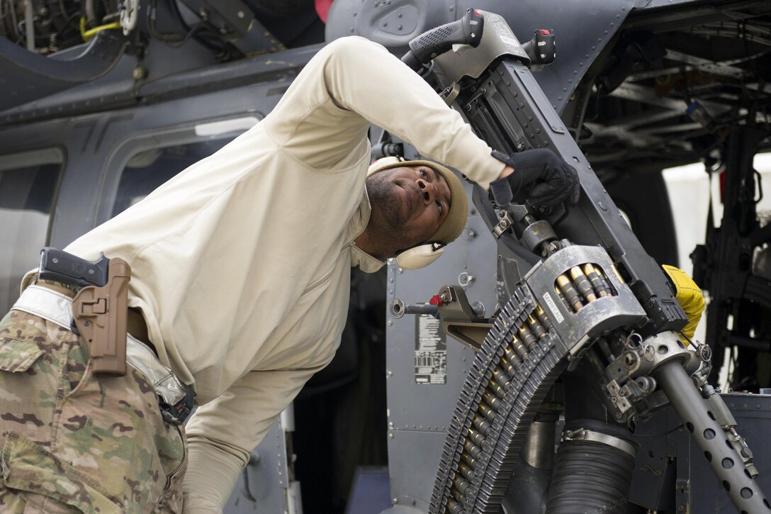 U.S. Air Force Staff Sgt. Mackel Stafford performs checks on an M2 .50-caliber machine gun on an HH-60 Pave Hawk helicopter on Bagram Airfield, Afghanistan, Dec. 26, 2015. Stafford is a lead weapons technician assigned to the 455th Expeditionary Aircraft Maintenance Squadron. U.S. Air Force photo by Tech. Sgt. Robert Cloys