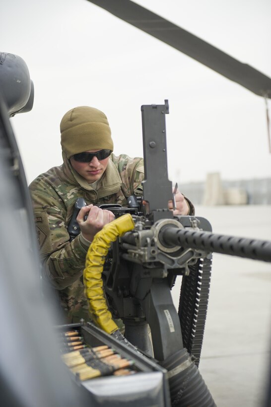 U.S. Air Force Senior Airman Matthew Meyer inspects an M2 .50-caliber machine gun on an HH-60 Pave Hawk helicopter during a preflight check at Bagram Airfield, Afghanistan, Dec. 26, 2015. Meyer is assigned to the 455th Expeditionary Aircraft Maintenance Squadron. U.S. Air Force photo by Tech. Sgt. Robert Cloys
