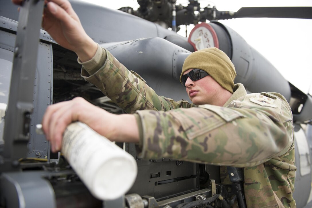 U.S. Air Force Senior Airman Matthew Meyer cleans and lubricates an M2 .50-caliber machine gun on an HH-60 Pave Hawk helicopter during a preflight check at Bagram Airfield, Afghanistan, Dec. 26, 2015. Meyer is assigned to the 455th Expeditionary Aircraft Maintenance Squadron. U.S. Air Force photo by Tech. Sgt. Robert Cloys