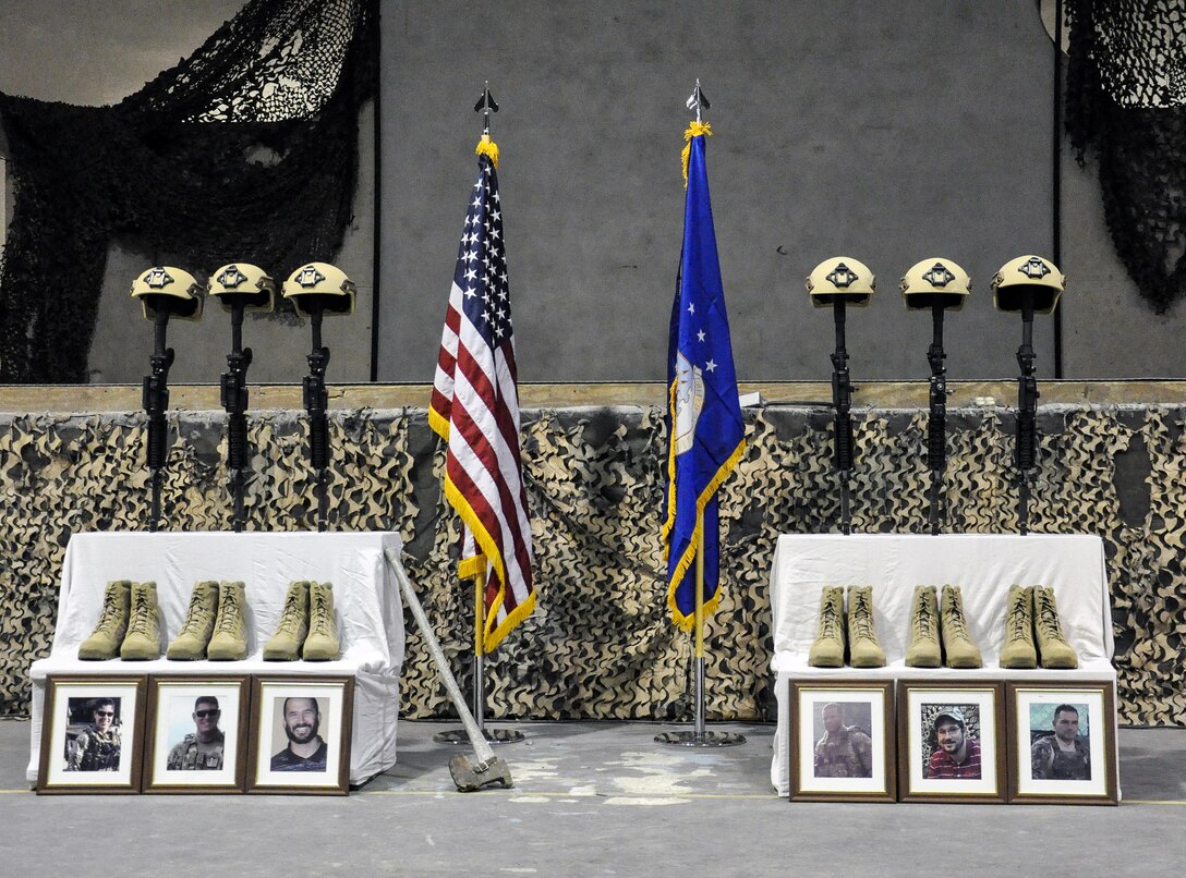 U.S. service members pay their respects during a ceremony on Bagram Airfield, Afghanistan, Dec. 23, 2015, to honor six airmen killed in a vehicle bomb attack on their patrol outside Bagram. U.S. Air Force photo by Tech. Sgt. Nicholas Rau