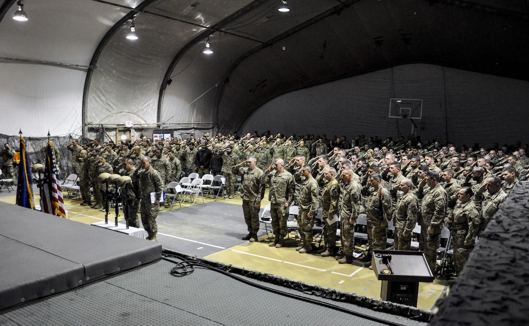 U.S. service members render honors as others pay their respects during a ceremony on Bagram Airfield, Afghanistan, Dec. 23, 2015, to honor six airmen killed in a vehicle bomb attack on their patrol outside Bagram. U.S. Air Force photo by Tech. Sgt. Nicholas Rau