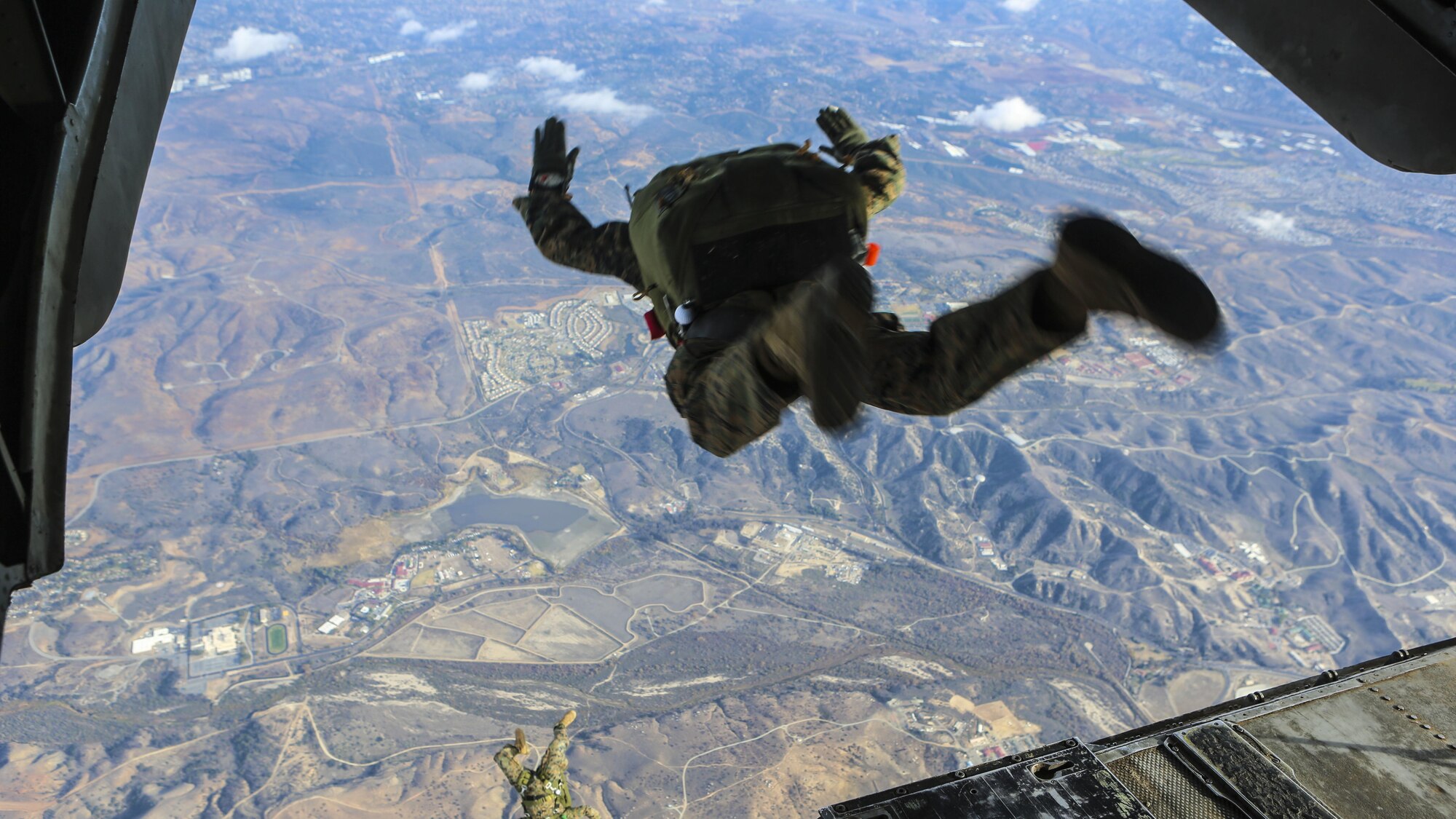 Marines with the 1st Expeditionary Operations Training free fall at 10,000 feet above Drop Zone Basilone, Marine Corps Base Camp Pendleton, California, Dec. 21. Marine Heavy Helicopter Squadron 462 supported the 1st EOTG in their parachute-operations training. This training is intended to improve the Marines’ skill for future uses of this knowledge, such as a deployment situation. Units like the 1st EOTG deploy often and this training allows the Marines to be ready to deploy at a moment’s notice.