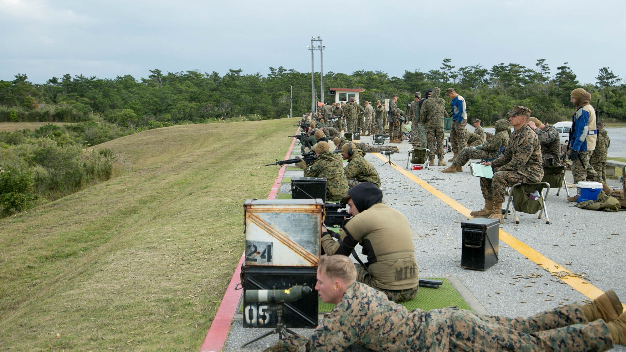 Shooters fire on their targets during the Far East Division Marksmanship Match Dec. 17 aboard Camp Hansen, Okinawa, Japan. The winners of the competition received medals and a chance to become part of the Marine Corps Shooting Team. Only Marines stationed throughout Japan competed in the match.