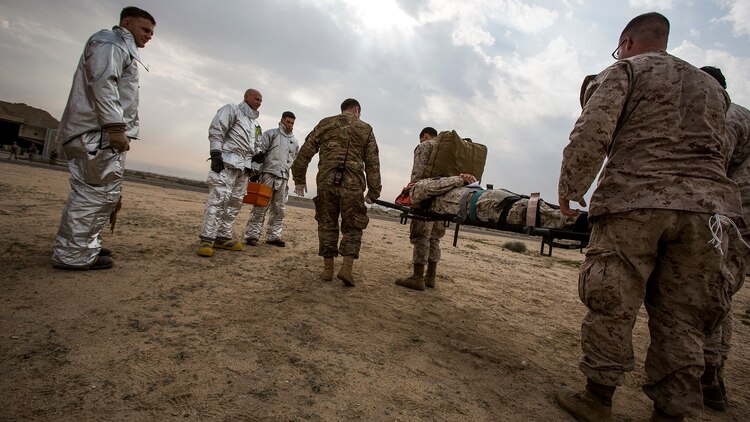 U.S. Navy and Air Force medical personnel transport a simulated casualty on a stretcher during a mass casualty exercise at an undisclosed location in Southwest Asia, Dec. 23, 2015. Canadian forces, U.S. Air Force and Army medical personnel, along with U.S. Marines and Navy corpsmen with Special Purpose Marine Air Ground Task Force – Crisis Response – Central Command, participated in the joint exercise to hone the coalition’s medical response capabilities.  SPMAGTF-CR-CC is currently deployed to the U.S. Central Command area of responsibility with a mission spanning 20 nations.