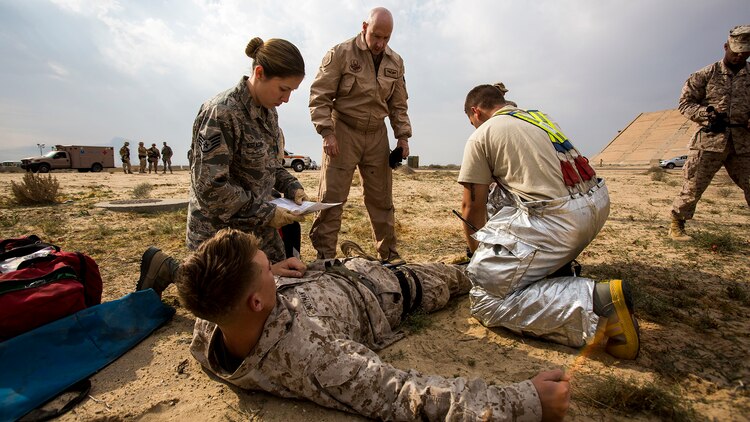 U.S. Air Force medical personnel perform initial triage on a simulated casualty during a mass casualty exercise at an undisclosed location in Southwest Asia, Dec. 23, 2015. Canadian forces, U.S. Air Force and Army medical personnel, along with U.S. Marines and Navy corpsmen with Special Purpose Marine Air Ground Task Force – Crisis Response – Central Command, participated in the joint exercise to hone the coalition’s medical response capabilities.  SPMAGTF-CR-CC is currently deployed to the U.S. Central Command area of responsibility with a mission spanning 20 nations.
