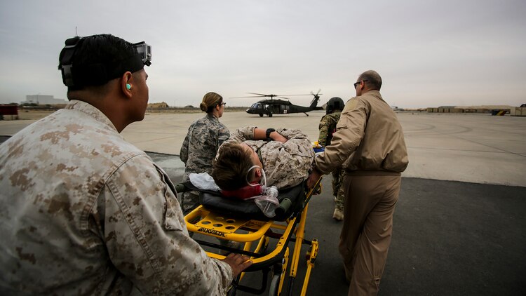 U.S. Air Force and Navy medical personnel prepare to load a simulated casualty onto a UH-60 “Black Hawk” helicopter during a mass casualty exercise at an undisclosed location in Southwest Asia, Dec. 23, 2015. Canadian forces, U.S. Air Force and Army medical personnel, along with U.S. Marines and Navy corpsmen with Special Purpose Marine Air Ground Task Force – Crisis Response – Central Command, participated in the joint exercise to hone the coalition’s medical response capabilities.  SPMAGTF-CR-CC is currently deployed to the U.S. Central Command area of responsibility with a mission spanning 20 nations.
