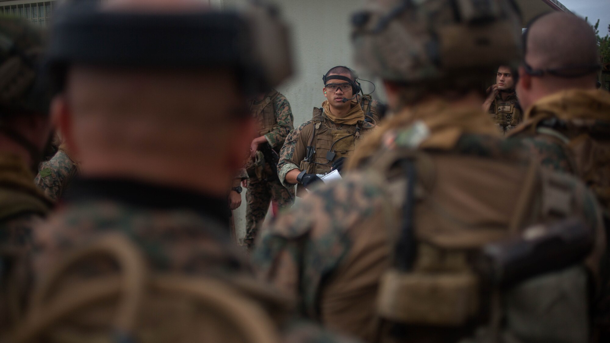 Cpl. Bryan Loos, a Maritime Raid Force intelligence analyst, briefs MRF Marines before conducting a raid Dec. 10, 2015, on Camp Hansen, Okinawa, Japan. The raid was part of the MRF’s Interoperability Exercise 16-1. INTEROP brings together all of the elements of the MRF and the 31st Marine Expeditionary Unit so they can identify any deficiencies, work through them, and build standard operating procedures. Loos, from Stafford, Virginia, is with the MRF, 31st MEU. 