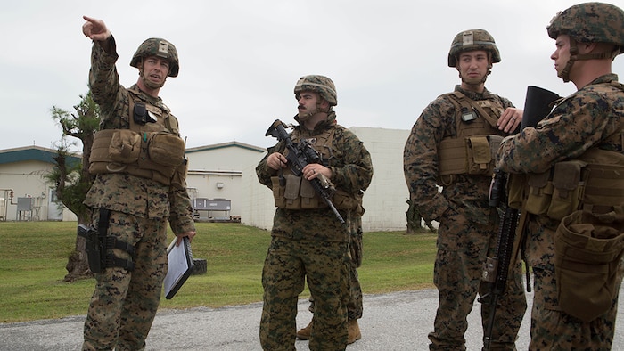 Capt. Albert Bellamy, far left, the commanding officer of Golf Battery, Battalion Landing Team 1st Battalion, 5th Marines, 31st Marine Expeditionary Unit, points to where he wants a security checkpoint setup at Camp Courtney in Okinawa, Japan, Dec. 15, 2015. The battery was training to distribute food and water as part of a humanitarian assistance and disaster relief operation when the crowd, played by other Marines, became unruly. A quick reaction force was called to help restore order and continue to distribute supplies. The HADR training was conducted as part of the 31st MEU’s Marine Expeditionary Unit Exercise. Capt. Bellamy is from Wadsworth, Ohio.