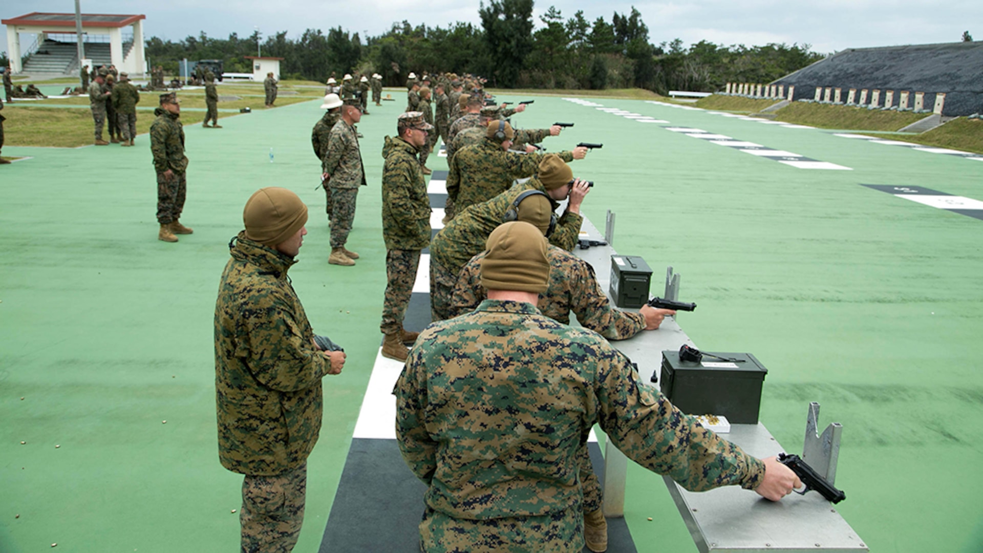 Shooters fire pistols during the Far East Division Marksmanship Match Dec. 17 aboard Camp Hansen, Okinawa, Japan. The competition consisted of classes, practice, and qualifications for both pistol and rifle marksmanship. Marine Aircraft Team 36 won the pistol marksmanship competition and 4th Marine Regiment won the rifle marksmanship competition. 