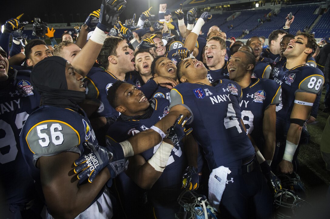 Navy football players sing Queen's "We are the Champions" to celebrate Navy's 44-28 victory over Pittsburgh in the 2015 Military Bowl at Navy-Marine Corps Memorial Stadium in Annapolis, Md., Dec. 28, 2015. DoD News photo by EJ Hersom