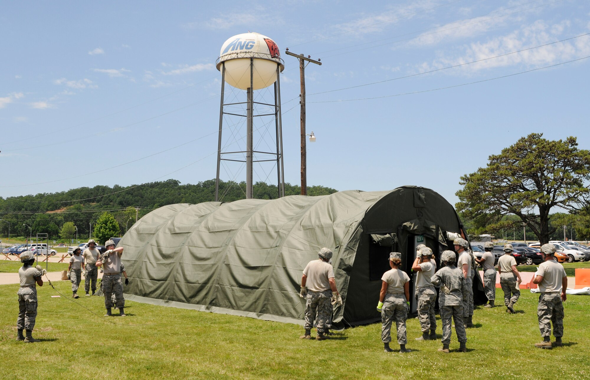 Members of the 188th Force Support Squadron assemble a small shelter system during annual training at Ebbing Air National Guard Base, Ark., June 8, 2015. Building a SSS is an annual training requirement for FSS Airmen.  The SSS requires a minimum of four personnel for set up and provides living quarters for 12 people. (U.S. Air National Guard photo by Staff Sgt. Hannah Dickerson/Released)