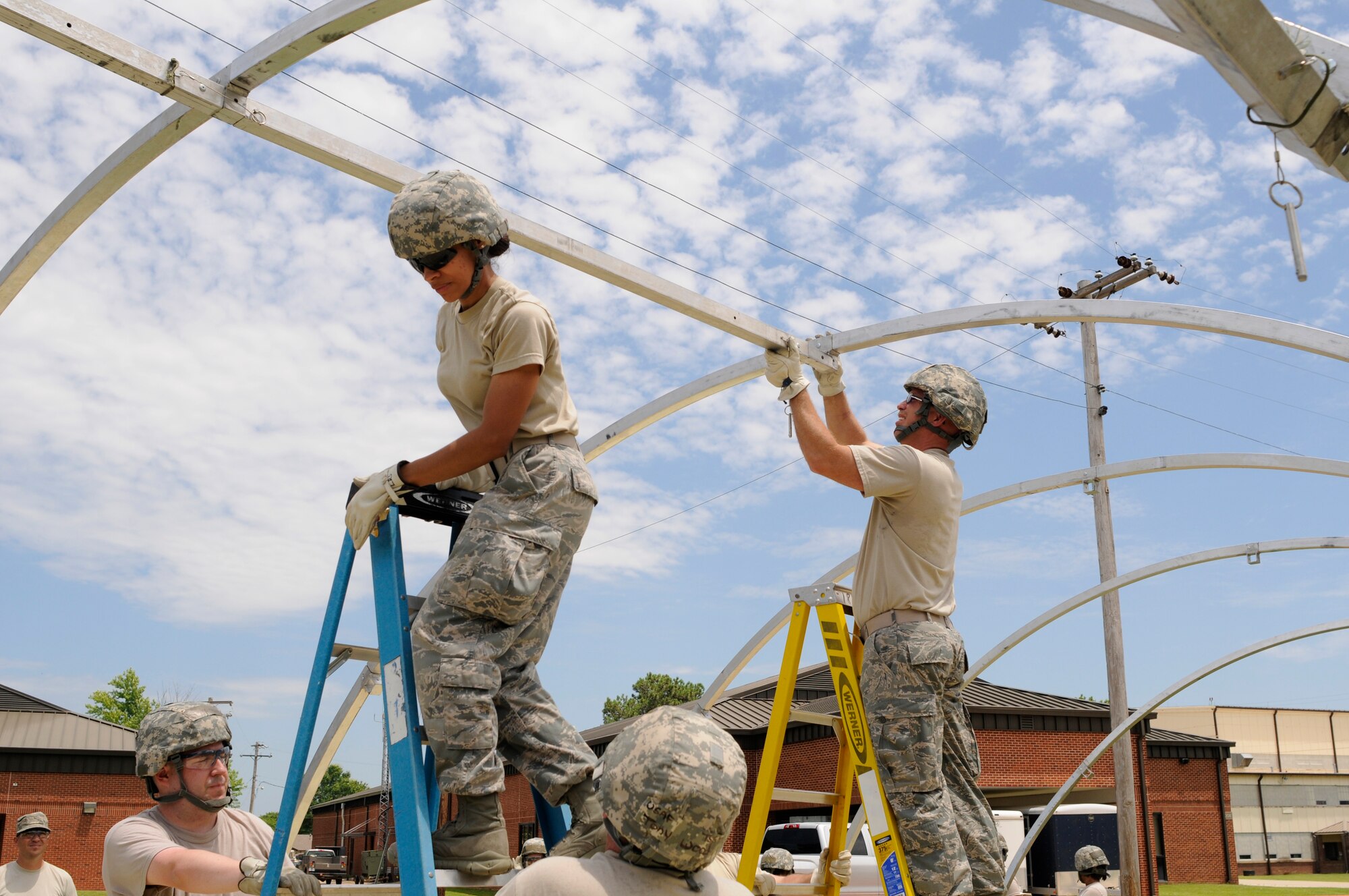 Members of the 188th Force Support Squadron assemble a small shelter system during annual training at Ebbing Air National Guard Base, Ark., June 8, 2015. Building a SSS is an annual training requirement for FSS Airmen.  The SSS requires a minimum of four personnel for set up and provides living quarters for 12 people. (U.S. Air National Guard photo by Staff Sgt. Hannah Dickerson/Released)