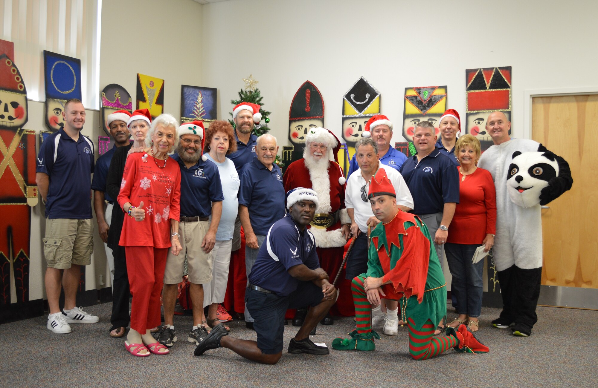 Members of the Space Coast Chiefs group, volunteers, and Santa pose for a picture following ‘A Visit with Santa’ event held Dec. 12, 2015, at the Patrick Air Force Base Shark Center, Florida. Jolly Old Saint Nicholas provided gifts for 190 kids, and a total of 257 guests attended the event.  (Courtesy Photo)