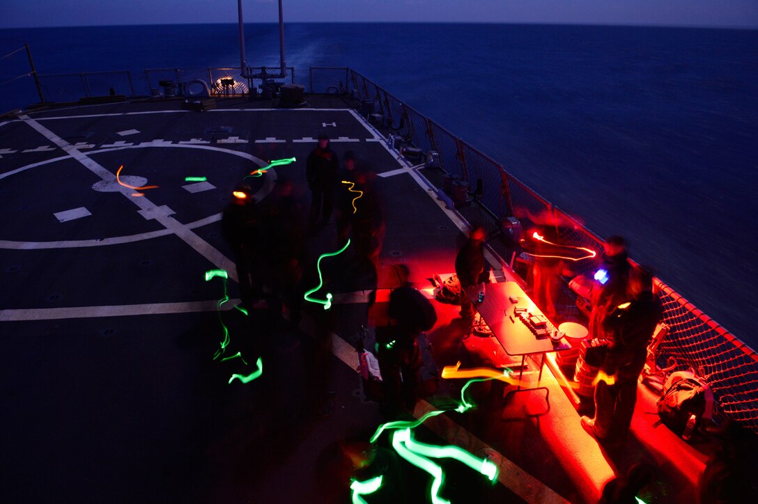U.S. sailors prepare to conduct low-light shooting operations aboard the USS Ross in the Mediterranean Sea, Dec. 19, 2015. U.S. Navy photo by Petty Officer 2nd Class Justin Stumberg