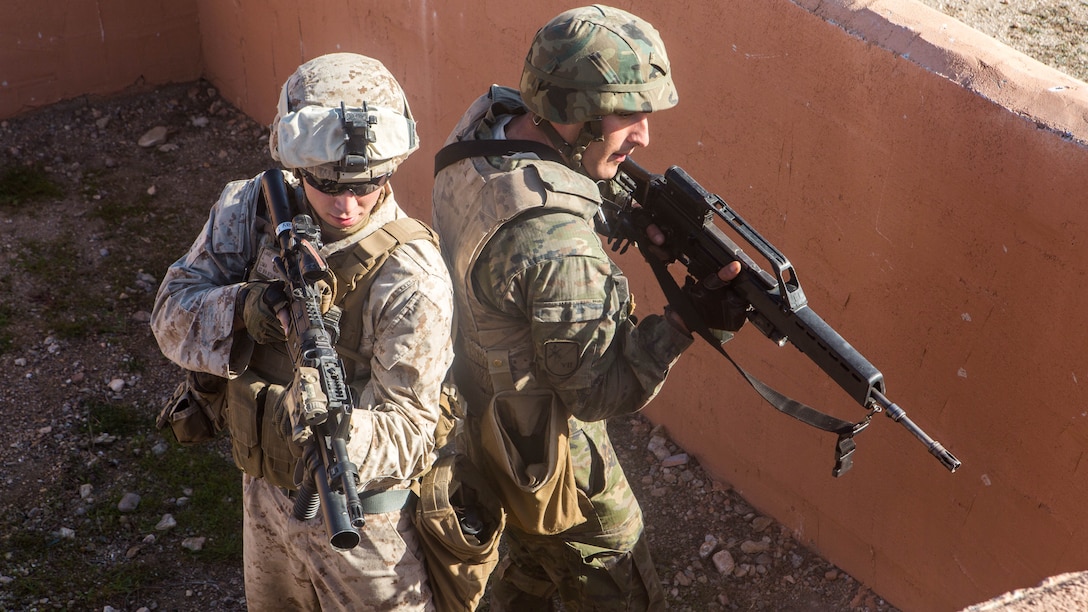 A U.S. Marine and a Spanish Legionnaire clear a compound during a military operations in urban terrain exercise, near Almeria, Spain, Dec. 15. The MOUT exercise is part of week-long bi-lateral exercise, embedding a platoon of U.S. Marines with the Spanish Legion.