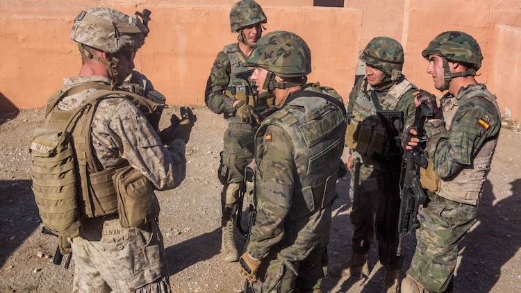 U.S. Marines with Special-Purpose Marine Air-Ground Task Force Crisis Response-Africa discuss lessons learned with Spanish Legionnaires during a military operations in urban terrain exercise, Dec. 15, near Almeria, Spain. More than 100 U.S. Marines and Spanish Legionnaires participated in a week-long training exercise.
