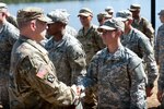 Maj. Gen. Scott Miller, commander, Maneuver Center of Excellence, shakes hands with Capt. Kristen M. Griest, one of the latest Soldiers to earn the Ranger tab on Fort Benning, Ga., Aug. 21, 2015.