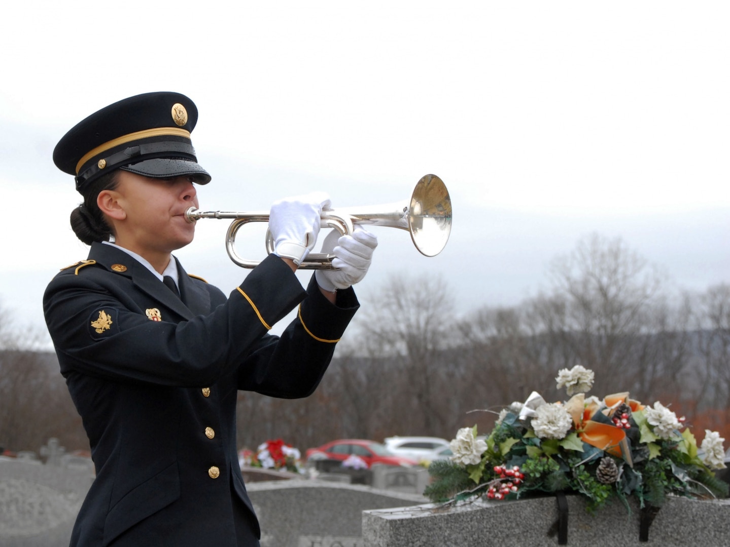 New York Army National Guard Honor Guard member Spc. Taylor Kuchera plays "Taps" to honor WWII veteran Leo P. Dean during Dean's funeral at St. Mary's Cemetery in Waterford, N.Y., Dec. 17, 2015. Kuchera is from Kingston, N.Y.