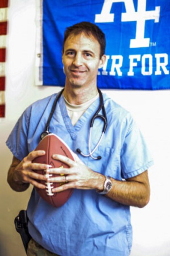Air Force Dr. (Maj.) Cale Bonds, an orthopedic surgeon with the 455th Expeditionary Medical Group, poses for a picture in his office at the Craig Joint Theater Hospital on Bagram Air Field, Afghanistan, Dec. 27, 2015. Bonds had played starting quarterback for the U.S. Air Force Academy’s Falcons football team. U.S. Air Force photo by Tech. Sgt. Nicholas Rau