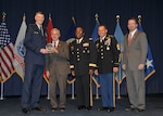 DLA director Air Force Lt. Gen. Andy Busch, left, presents Perry Knight, chief integration officer at Defense Logistics Agency Distribution, with the Leader of the Year award at the 48th annual employee recognition ceremony Dec. 10. Distribution’s commander Army Brig. Gen. Richard Dix, third from right, DLA’s Senior Enlisted Leader Army Command Sgt. Maj. Charles Tobin, second from right, and Brad Bunn, right, Director of Human Resources, were also on-hand to present the award.