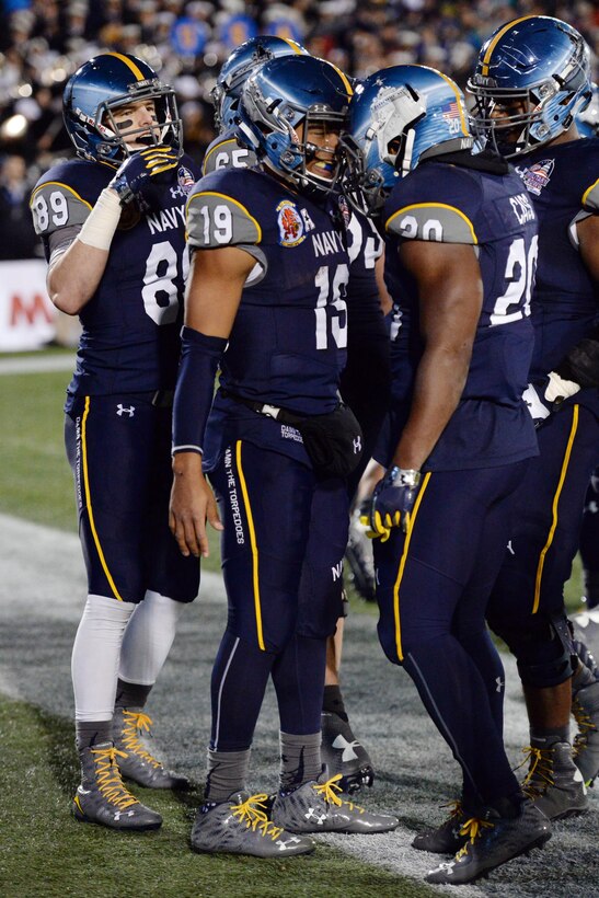Navy quarterback Keenan Reynolds, center, reacts to his record-breaking touchdown in the 2015  Military Bowl at Navy-Marine Corps Memorial Stadium in Annapolis, Md., Dec. 28, 2015. DoD News photo by EJ Hersom