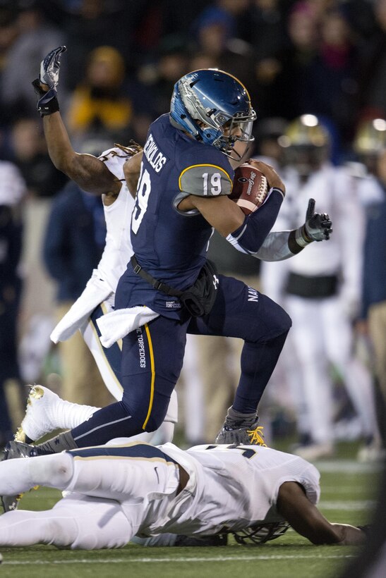 Navy quarterback Keenan Reynolds evades tackles during the 2015 Military Bowl at Navy-Marine Corps Memorial Stadium in Annapolis, Md., Dec. 28, 2015. DoD News photo by EJ Hersom