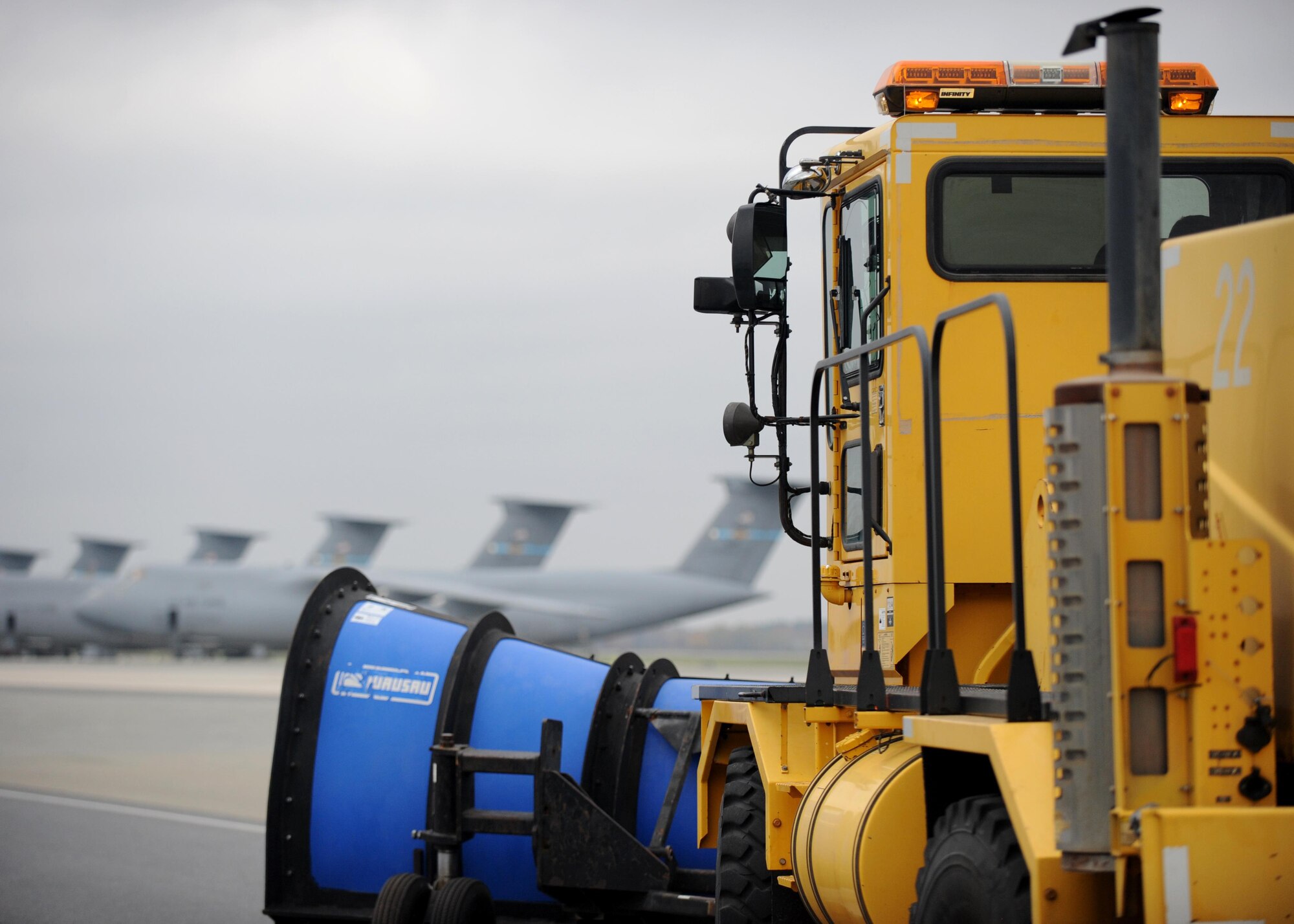A snow plow leads the annual snow parade down the flight line Nov. 6, 2015, at Dover Air Force Base, Del. Wing leadership had the opportunity to drive airfield snow plows, blowers and broom type airfield snow removal vehicles. (U.S. Air Force photo/Tech. Sgt. Elizabeth Morris) 