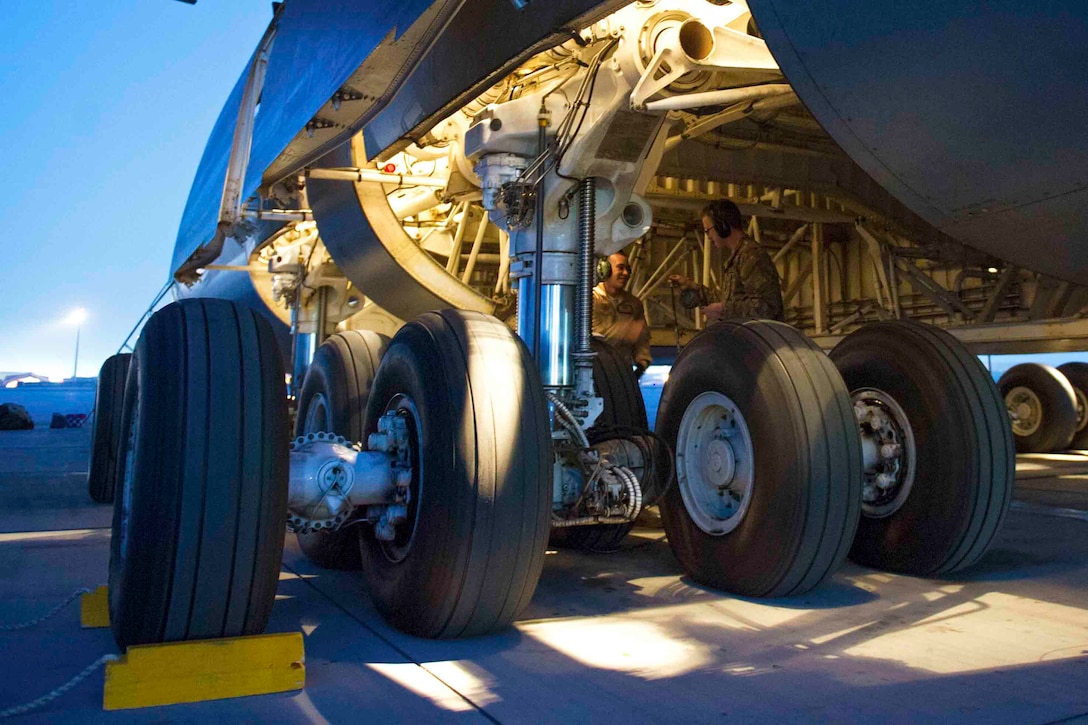 U.S. maintainers work in the wheel well of a C-5 Galaxy on Bagram Airfield, Afghanistan, Dec. 28, 2015. The C-5 Galaxy is a heavy airlifter with intercontinental range and is the largest U.S. military aircraft capable of carrying more than 270,000 pounds of cargo. U.S. Air Force photo by Tech. Sgt. Robert Cloys