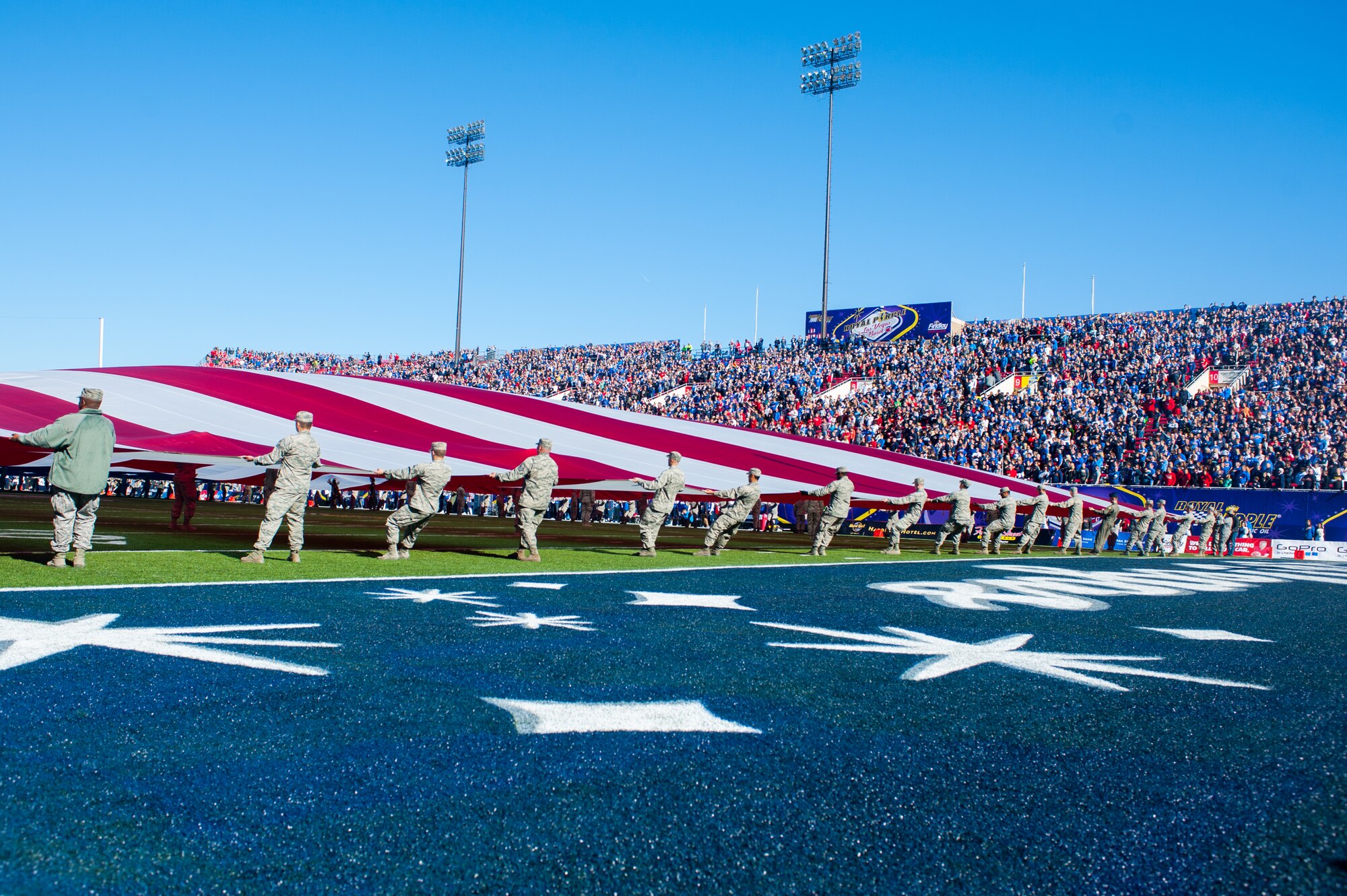 Airmen from Nellis Air Force Base, Nev., hold a 100-yard U.S. flag during the opening ceremony of the Royal Purple Las Vegas Bowl at Sam Boyd Stadium in Las Vegas, Dec. 19, 2015. The flag was carried across the entire field and supported by 180 Airmen during the playing of the national anthem. (U.S. Air Force photo by Tech. Sgt. Christopher Holmes) 