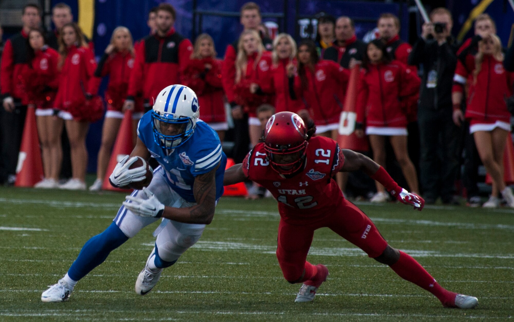 Utah defensive back Justin Thomas (right) tries to tackle Brigham Young University wide receiver Terenn Houk during the Royal Purple Las Vegas Bowl at Sam Boyd Stadium in Las Vegas, Dec. 19, 2015. The Utah Utes were able to hold off a late-game rally by the BYU Cougars and win 35-28. (U.S. Air Force photo by Senior Airman Thomas Spangler)