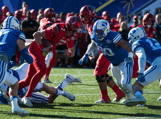 Utah quarterback Travis Wilson attempts to run for a first down against the Brigham Young University defense during the Royal Purple Las Vegas Bowl at Sam Boyd Stadium in Las Vegas, Dec. 19, 2015. The Utah Utes defeated the BYU Cougars 35-28. (U.S. Air Force photo by Senior Airman Thomas Spangler)