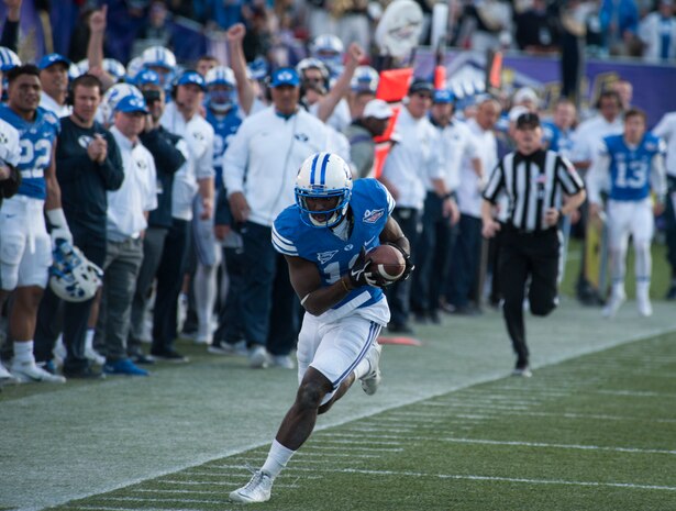 Brigham Young University wide receiver Devon Blackman tries to stay in bounds after catching a long pass during the Royal Purple Las Vegas Bowl at Sam Boyd Stadium in Las Vegas, Dec. 19, 2015. The BYU Cougars fell behind quickly in the first quarter 35-0 to the Utah Utes, rallied late in the game, but came up a touchdown short. (U.S. Air Force photo by Senior Airman Thomas Spangler)