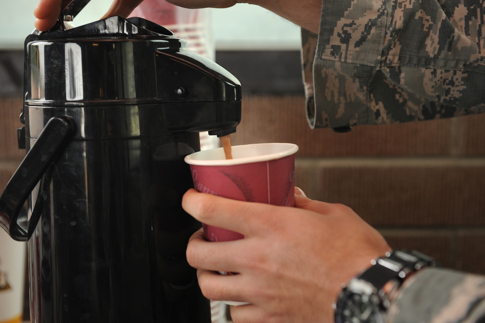 U.S. Air Force Staff Sgt. George Mena, 355th Fighter Wing chaplain’s assistant, pours hot chocolate at Davis-Monthan Air Force Base, Ariz., Dec. 14, 2015. Mena brought cups of hot chocolate to Airmen at entry control points around D-M. Visits like this are part of the Chaplain’s weekly routine to check on D-M’s Airmen. (U.S. Air Force photo by Senior Airman Cheyenne A. Powers/ Released)

