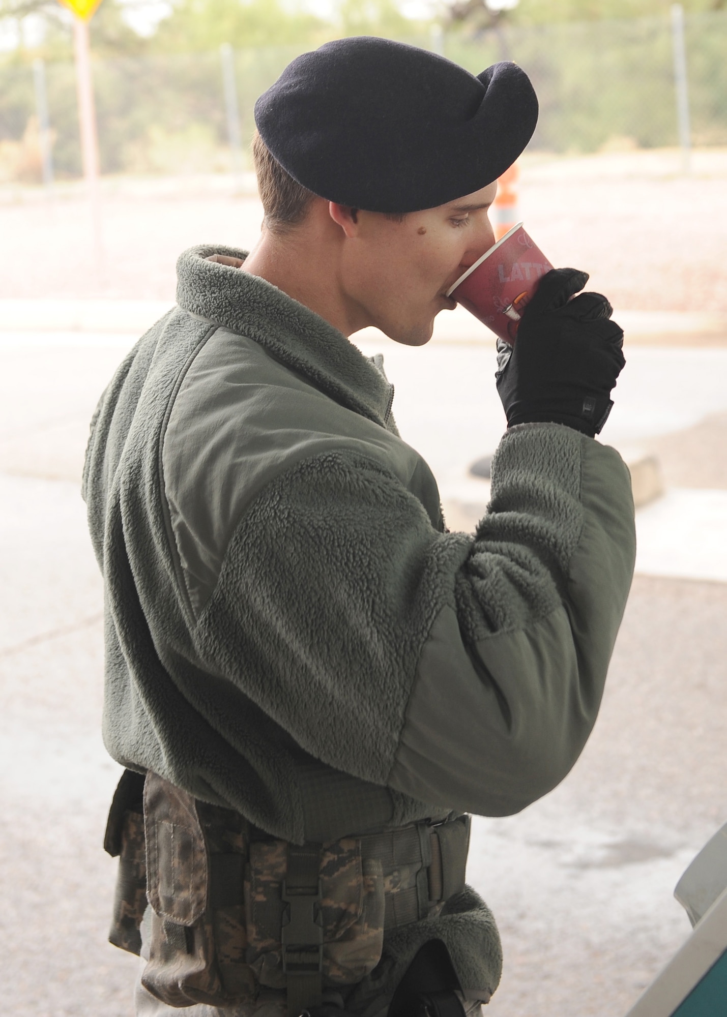 U.S. Air Force Senior Airman Christopher Mullis, 355th Security Forces Squadron, drinks a cup of hot chocolate at Davis-Monthan Air Force Base, Ariz., Dec. 14, 2015. The hot chocolate was provided by the Chaplain Corps and distributed to all SFS Airmen working at entry control points around D-M. (U.S. Air Force photo by Senior Airman Cheyenne A. Powers/ Released)
