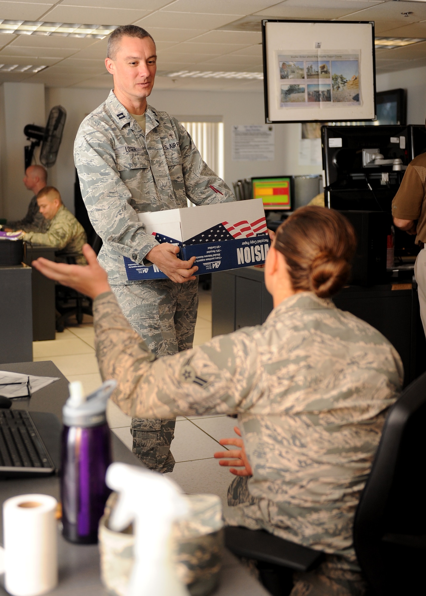 U.S. Air Force Chaplain (Capt.) Paul Loser, 355th Fighter Wing chaplain, talks with Airman 1st Class Ariel Hawkins, 25th Operational Weather Squadron weather forecaster, during a squadron visitation at Davis-Monthan Air Force Base, Ariz., Dec. 9, 2015. As a chaplain it is part of Loser’s job to routinely check on squadrons he is designated. These check-ups are called squadron visitations and occur two to three times a week. (U.S. Air Force photo by Senior Airman Cheyenne A. Powers/ Released)