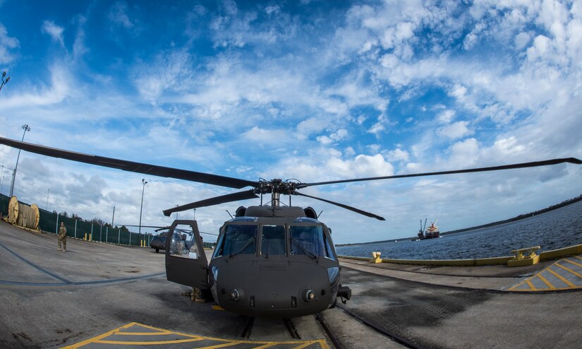 A UH-60 Black Hawk from the 3rd Combat Aviation Brigade sits on a dock Dec. 28, 2015 at Joint Base Charleston, S.C. Weapons Station. More than 20 helicopters returned to the U.S. from various United States European Command bases via cargo ship. The 841st Transportation Battalion from Joint Base Charleston unloaded the helicopters and the 3rd CAB flew the aircraft back to their home  station, Hunter Army Airfield, Ga.. (U.S. Air Force photo/Senior Airman Jared Trimarchi) 