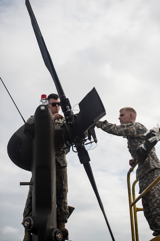 Soldiers from the 3rd Combat Aviation Brigade fix the tail rotor of a UH-60 Black Hawk, Dec. 28, 2015, at Joint Base Charleston, S.C. Weapons Station. More than 20 helicopters returned to the U.S. from various United States European Command bases via cargo ship. The 841st Transportation Battalion from Joint Base Charleston unloaded the helicopters and the 3rd CAB flew the aircraft back to their home  station, Hunter Army Airfield, Ga. (U.S. Air Force photo/Senior Airman Jared Trimarchi) 