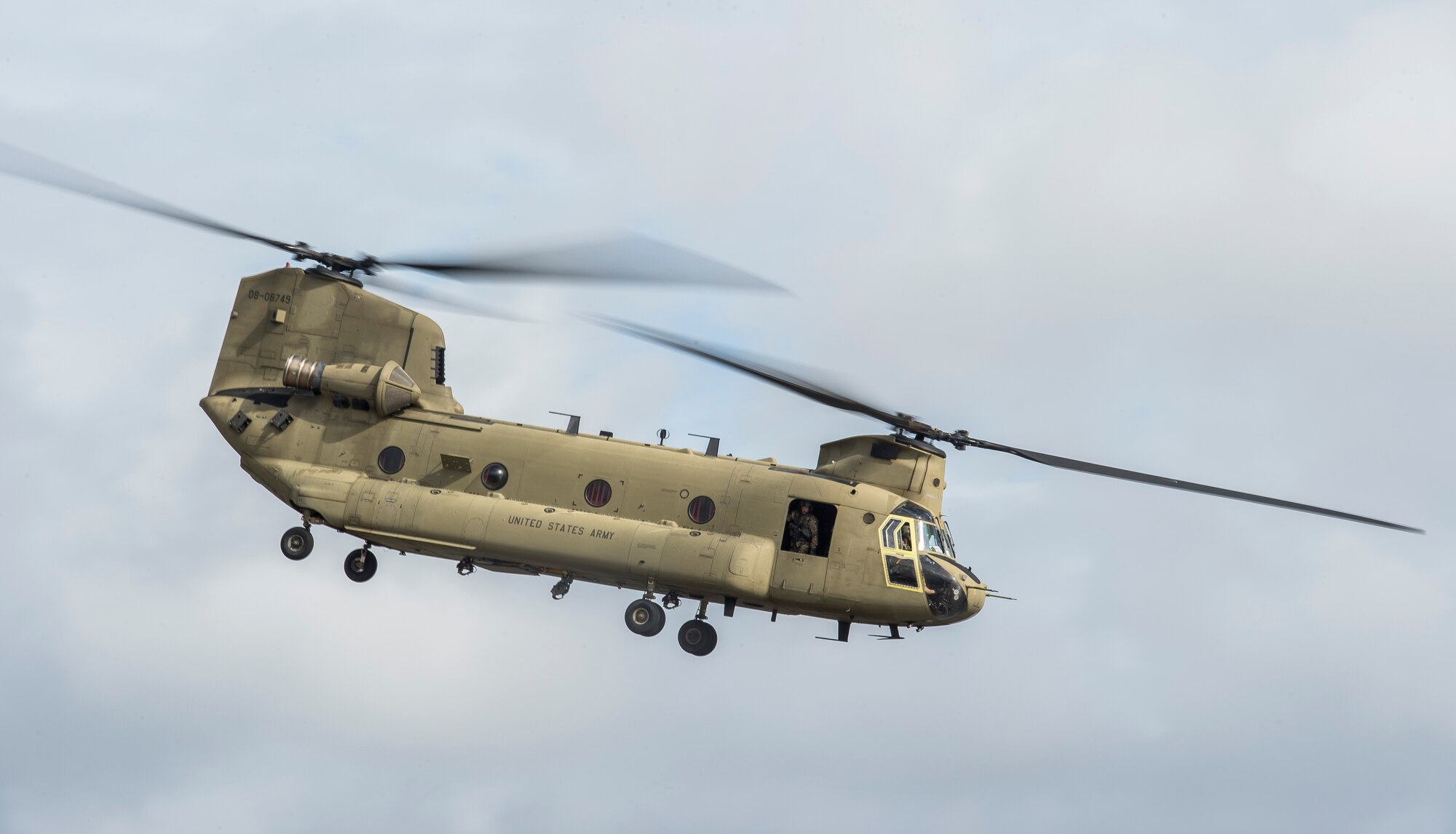 A soldier looks out the window of a CH-47 Chinook from the 3rd Combat Aviation Brigade Dec. 28, 2015 at Joint Base Charleston, S.C. Weapons Station. More than 20 UH-60 Black Hawk helicopters returned to the U.S. from various United States European Command bases via cargo ship. The 841st Transportation Battalion from Joint Base Charleston unloaded the helicopters and the 3rd CAB flew the aircraft back to their home  station, Hunter Army Airfield, Ga.  (U.S. Air Force photo/Senior Airman Jared Trimarchi) 