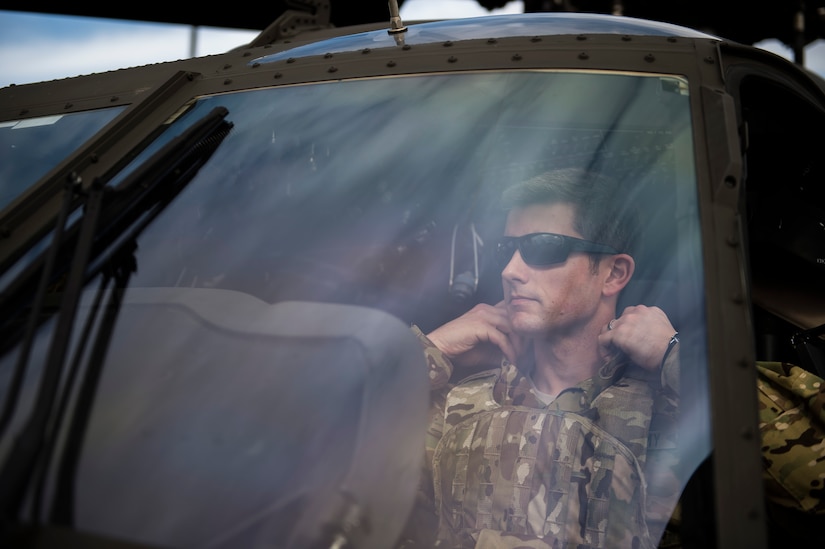Capt. Shawn Driver , a pilot from the 3rd Combat Aviation Brigade, closes his collar aboard a UH-60 Black Hawk Dec. 28, 2015 before taking off at Joint Base Charleston, S.C. Weapons Station. More than 20 helicopters returned to the U.S. from various United States European Command bases via cargo ship. The 841st Transportation Battalion from Joint Base Charleston unloaded the helicopters and the 3rd CAB flew the aircraft back to their home  station, Hunter Army Airfield, Ga. (U.S. Air Force photo/Senior Airman Jared Trimarchi) 