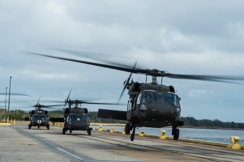 A UH-60 Black Hawk from the 3rd Combat Aviation Brigade takes off, Dec. 28, 2015, at Joint Base Charleston, S.C. Weapons Station. More than 20 helicopters returned to the U.S.  from various United States European Command bases via cargo ship. The 841st Transportation Battalion from Joint Base Charleston unloaded the helicopters and the 3rd CAB flew the aircraft back to their home  station, Hunter Army Airfield, Ga. (U.S. Air Force photo/Senior Airman Jared Trimarchi) 