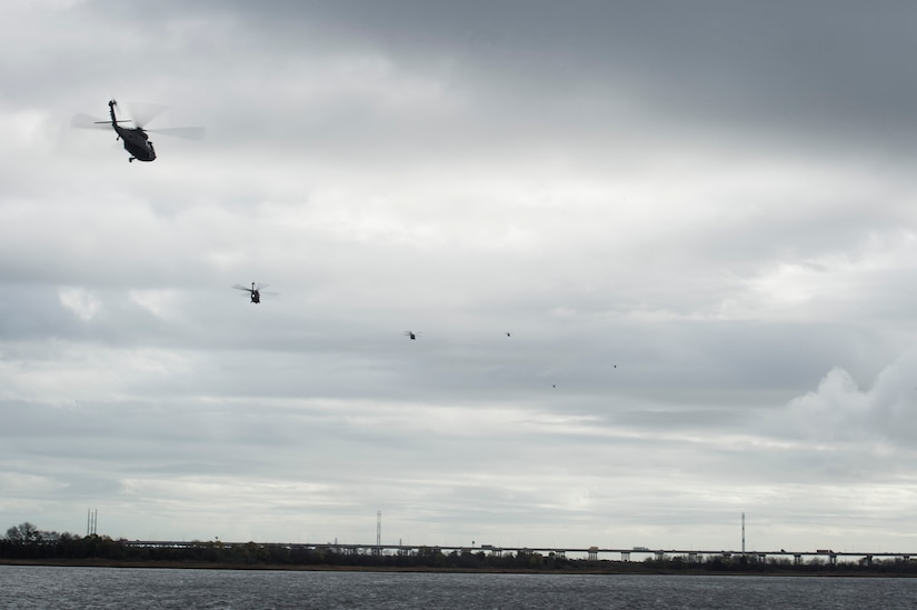 Six UH-60 Black Hawks from the 3rd Combat Aviation Brigade fly over the Cooper River Dec. 28, 2015 at Joint Base Charleston, S.C. Weapons Station. More than 20 helicopters returned to the U.S. from various United States European Command bases via cargo ship. The 841st Transportation Battalion from Joint Base Charleston unloaded the helicopters and the 3rd CAB flew the aircraft back to their home  station, Hunter Army Airfield, Ga. (U.S. Air Force photo/Senior Airman Jared Trimarchi) 