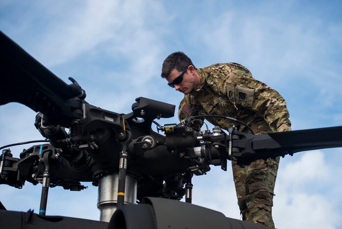 Capt. Shawn Driver , a pilot from the 3rd Combat Aviation Brigade, inspects the blades of a UH-60 Black Hawk, Dec. 28, 2015, before taking off at Joint Base Charleston, S.C. Weapons Station. More than 20 helicopters returned to the U.S. from various United States European Command bases via cargo ship. The 841st Transportation Battalion from Joint Base Charleston unloaded the helicopters and the 3rd CAB flew the aircraft back to their home  station, Hunter Army Airfield, Ga. (U.S. Air Force photo/Senior Airman Jared Trimarchi) 