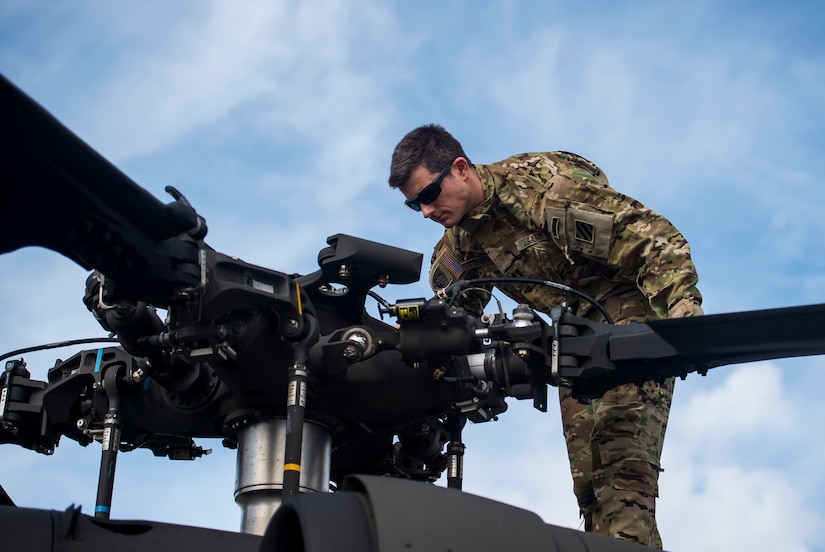 Capt. Shawn Driver , a pilot from the 3rd Combat Aviation Brigade, inspects the blades of a UH-60 Black Hawk, Dec. 28, 2015, before taking off at Joint Base Charleston, S.C. Weapons Station. More than 20 helicopters returned to the U.S. from various United States European Command bases via cargo ship. The 841st Transportation Battalion from Joint Base Charleston unloaded the helicopters and the 3rd CAB flew the aircraft back to their home  station, Hunter Army Airfield, Ga. (U.S. Air Force photo/Senior Airman Jared Trimarchi) 