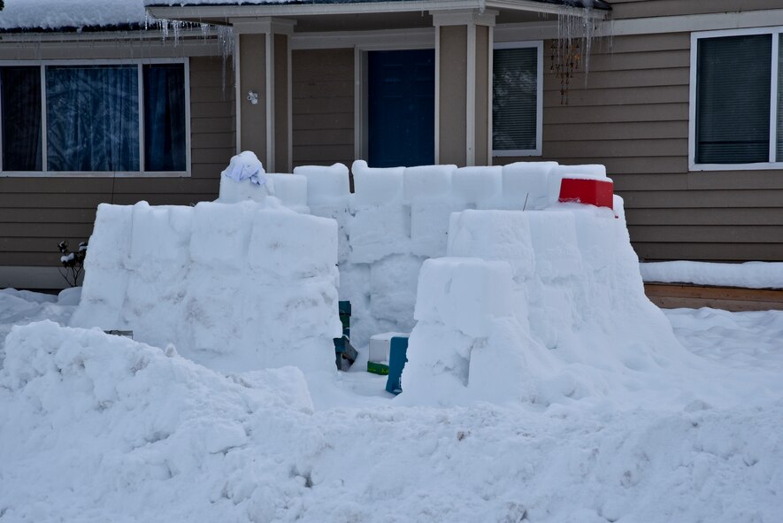 An igloo about four feet tall and ten feet wide was built by a family in base housing is on Fairchild Air Force Base, Wash. With the increased amount of snow this year many housing residents have decorated their lawns with different types of snow creations. (U.S. Air Force photo/Airman 1st Class Taylor Bourgeous)