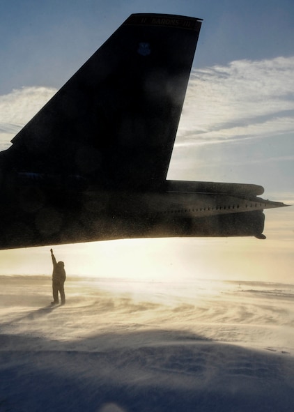 An Airman from the 5th Aircraft Maintenance Squadron stands underneath a B-52H Stratofortress at Minot Air Force Base, N.D., Jan. 8, 2015. The Airman performed preflight checks and removed engine covers before the Aircraft took off for a ten hour mission. (U.S. Air Force photo/Senior Airman Stephanie Morris)