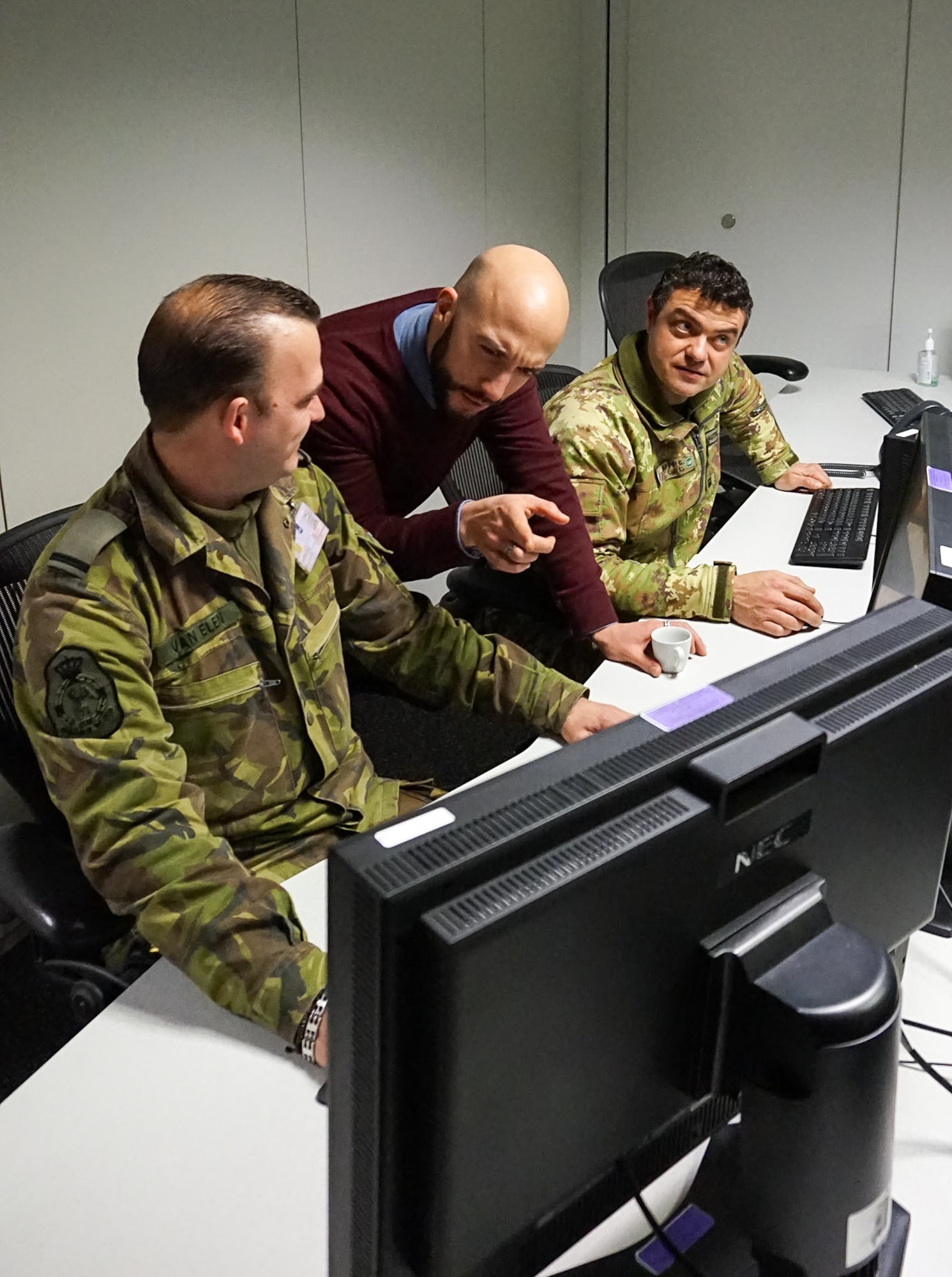 Matthew Sion, 1st Air and Space Communications Operations Squadron’s European Partner Integration Enterprise system support chief, center, speaks with coalition liaison officers Nov. 25, 2015, at Ramstein Air Base, Germany. During his time at the 1st ACOS, Sion and his team supported the development of a program designed to streamline the way intelligence products are made and distributed. (U.S. Air Force /Courtesy Photo)