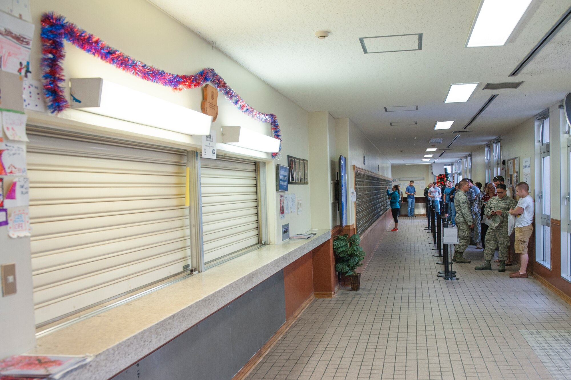 Post office customers line up early for packages, Dec. 30, 2015, at Kadena Air Base, Japan. Customers are asked to check their mailboxes daily to ensure there is room for the influx of packages during the holiday season. The pick-up window has resumed normal operating hours, they are open Monday through Saturday from 9 a.m. to 5:30 p.m. (U.S. Air Force photo by Airman Zackary A. Henry)