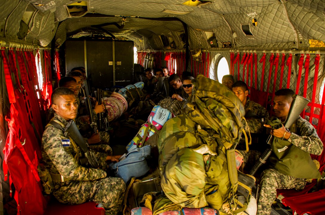 Honduran soldiers sit in the back of a U.S. Army CH-47 Chinook Dec. 16, 2015, prior to transiting to a remote area in the Gracias a Dios Department (state) of Honduras. The troops are a part of more than 4,900 Honduran troops the U.S. has helped to access hard to reach locations in the department since October 2014, where disrupting drug trafficking has been a primary focus for the Honduran government. (U.S. Air Force photo by Capt. Christopher Mesnard/Released)