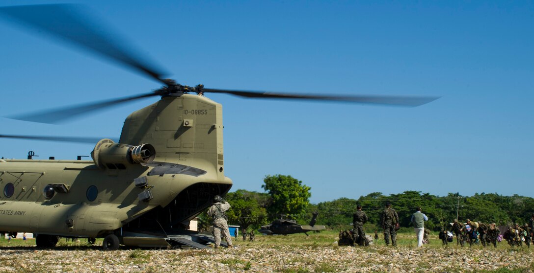 U.S. Army Sgt. David Pressnell, 1-228th Aviation Regiment flight engineer directs Honduran soldiers loading gear and personnel into the back of a U.S. Army CH-47 Chinook Dec. 16, 2015, in the Gracias a Dios Department (state) of Honduras during a troop movement the U.S. provides support to. The two day troop movement is a part of a larger operation called CARAVANA, which the U.S. has supported since October 2014, to assist the Honduran government in disrupting the flow of illicit trafficking through the area. (U.S. Air Force photo by Capt. Christopher Mesnard/Released)