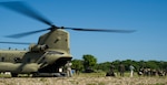 U.S. Army Sgt. David Pressnell, 1-228th Aviation Regiment flight engineer directs Honduran soldiers loading gear and personnel into the back of a U.S. Army CH-47 Chinook Dec. 16, 2015, in the Gracias a Dios Department (state) of Honduras during a troop movement the U.S. provides support to. The two day troop movement is a part of a larger operation called CARAVANA, which the U.S. has supported since October 2014, to assist the Honduran government in disrupting the flow of illicit trafficking through the area. (U.S. Air Force photo by Capt. Christopher Mesnard/Released)